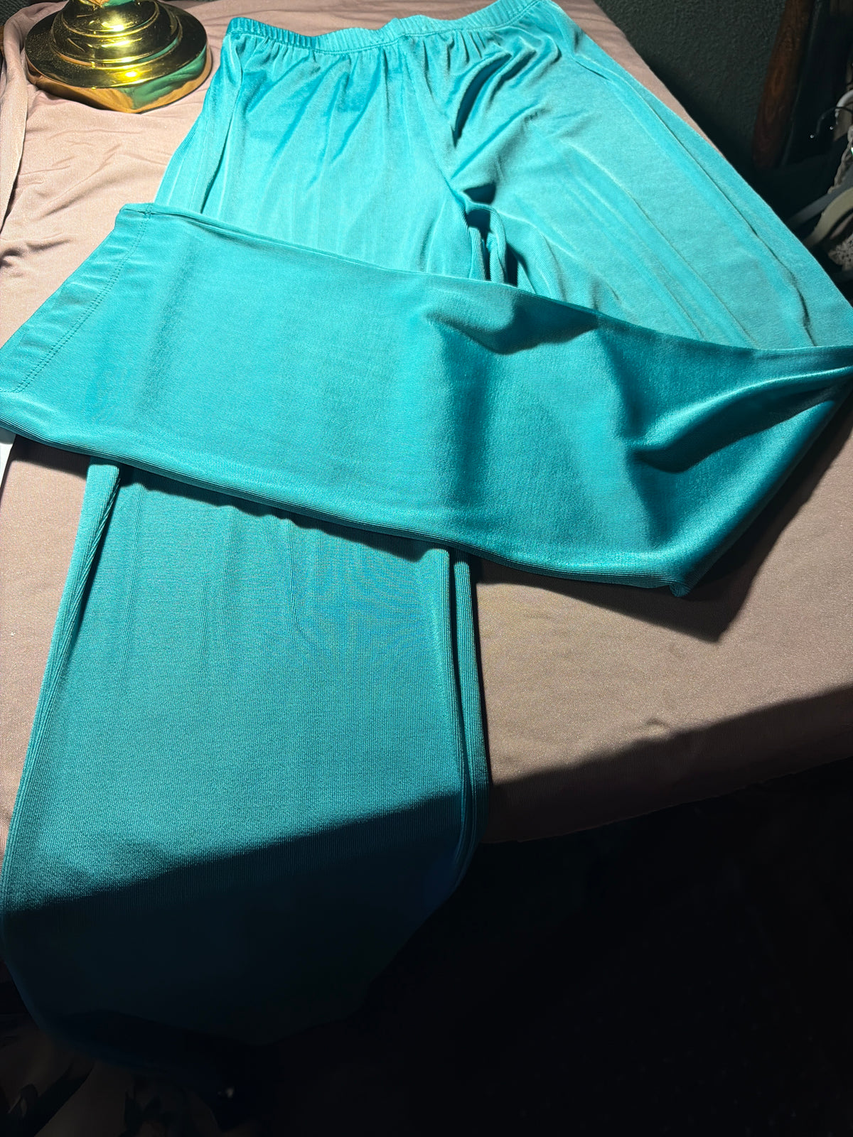 Vintage teal palazzo pants and bandeau top set laid flat on bed