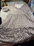 Tape measure shown on a detail of the taupe and ivory spotted dress