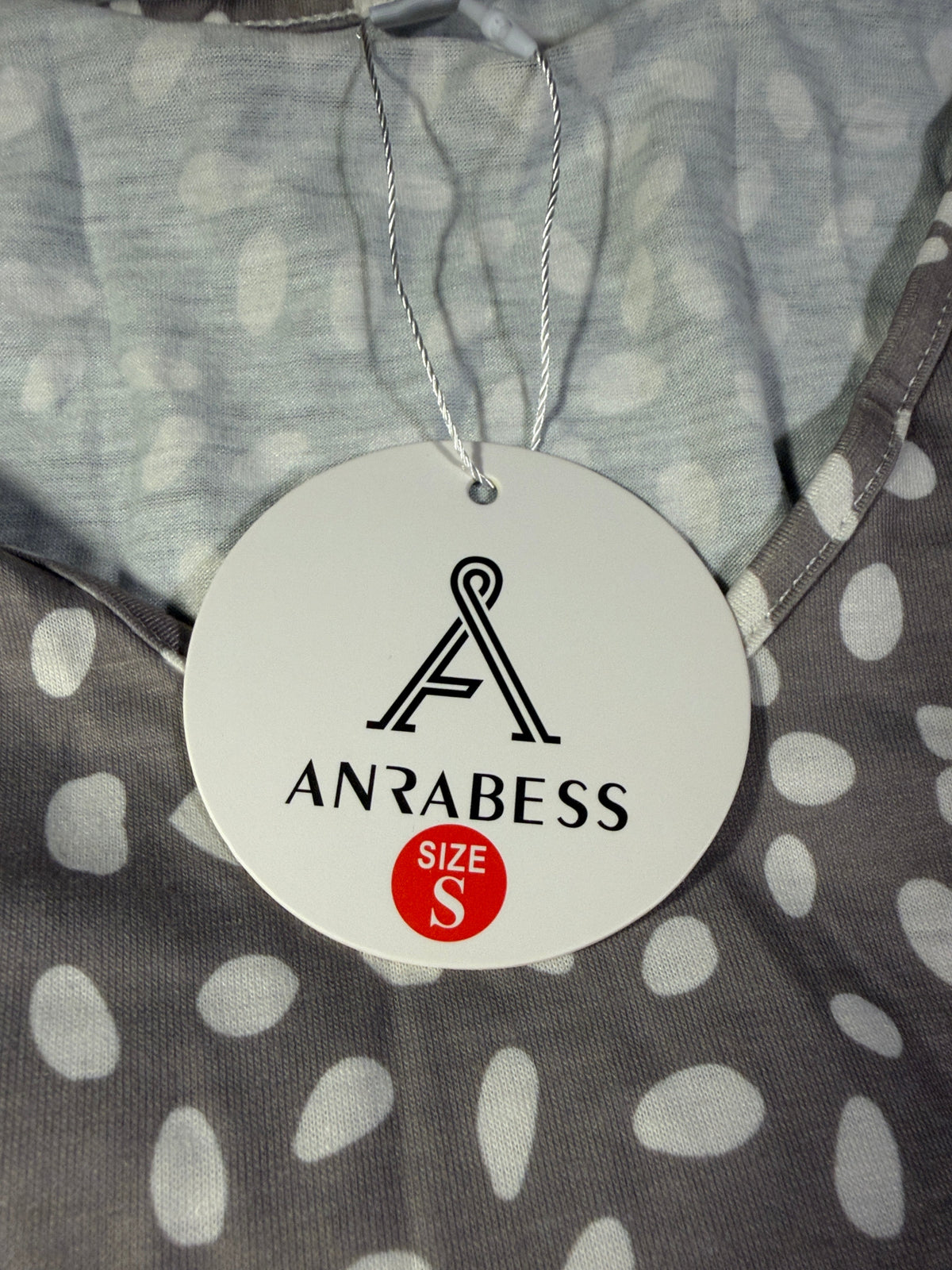 ANRABESS hangtag showing size S attached to the spotted dress